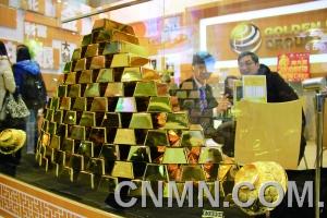 參展的金行在現(xiàn)場展臺用金磚壘出小“金字塔”，吸引了眾多投資者的目光。